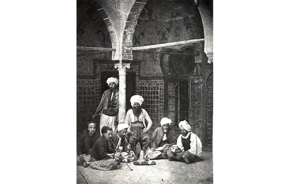 Arab men smoking pipe and drinking Turkish coffee in a coffee shop corner in Jerusalem