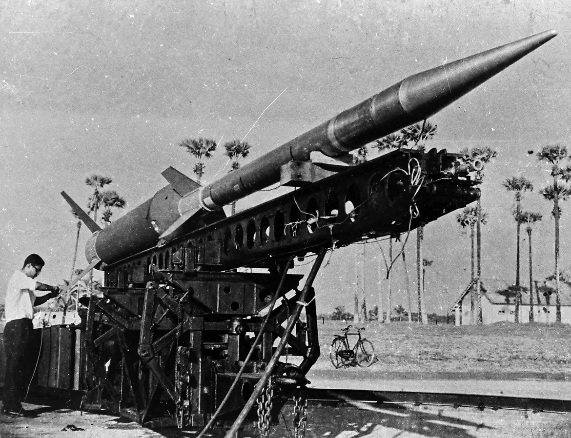 NASA also supplied Nike-Apache sounding rockets (including the one for the inaugural flight) and some tracking equipment. Nike is the name of the booster (or the first stage) while Apache is the name of the second stage. The picture shows an assembled Nike-Apache at Thumba. Note the bicycle in the background; it was the only readily available mode of transport in TERLS in the 1960s