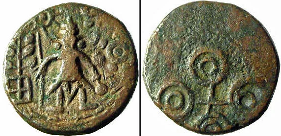Standing Shiva holding danda in right and kamandalu in left; sun above railed tree on left and six-armed symbol on right; taurine on top; river at bottom; Double orbed Ujjain symbol