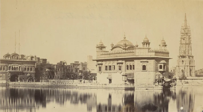 The gothic clock tower seen in the background of the Golden Temple