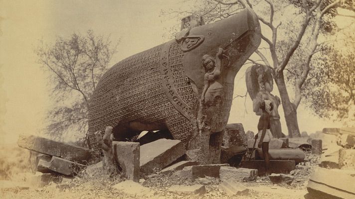 The Eran Varaha boar statue with ruins in late 19th-century, showing the relief on the boar’s body 