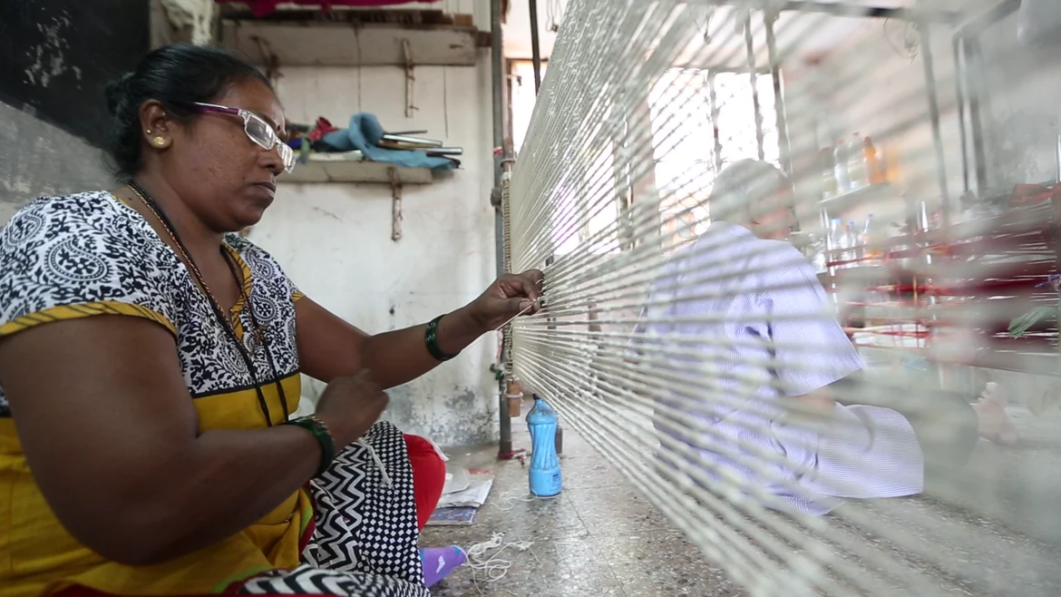 A woman in Patan, tying the threads for dyeing
