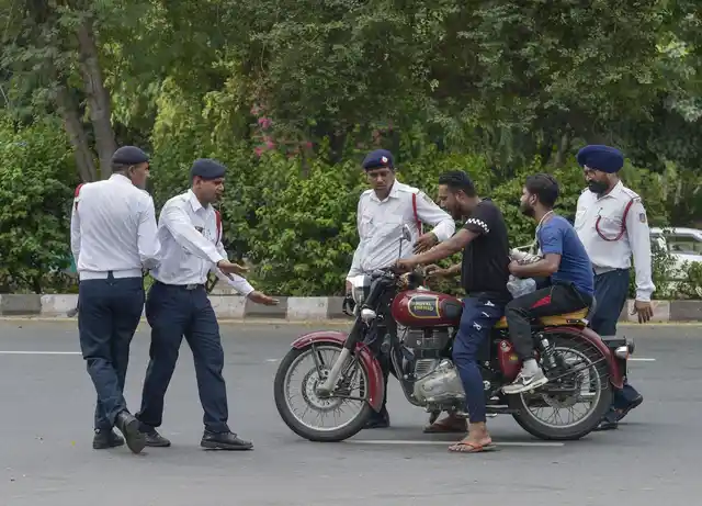 1 सितंबर को मोटर व्हीकल एक्ट के लागू होने के बाद ट्रैफिक पुलिसकर्मी बिना हेलमेट मोटर साइकिल सवार लोगों को रोकते हुए
