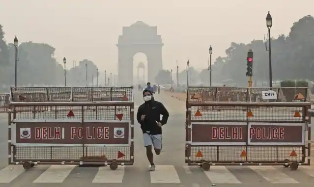 नई दिल्ली में एक जॉगर पॉल्यूशन मास्क पहनकर दौड़ लगाता हुआ(28 अक्टूबर)