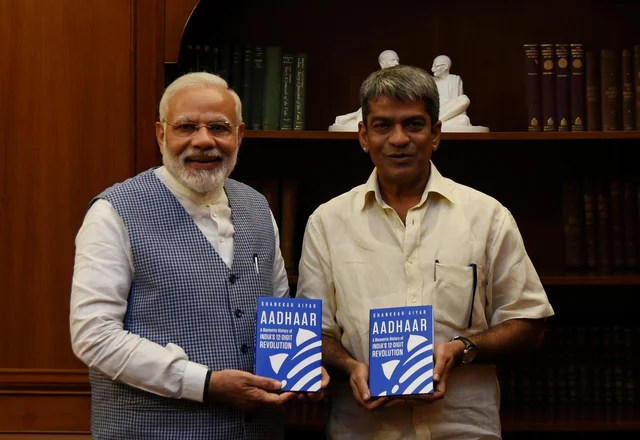 The author presents a copy of his book to Prime Minister Modi 