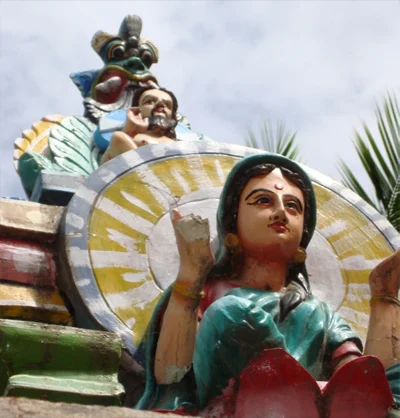 Image of Mary seated at the feet of Christian male deity: yet confused with Mariamman – the goddess.