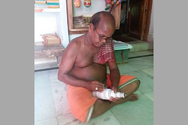 Sudam Chandra Sahoo creates artwork on a bottle