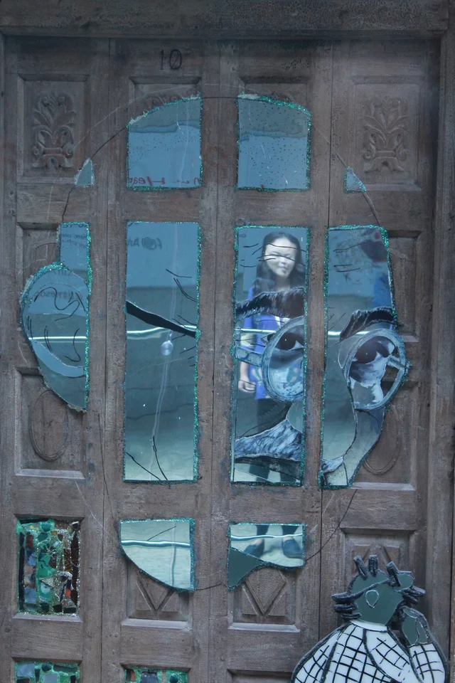 In reflection: A viewer “sees” herself in a portrait of Mahatma Gandhi.