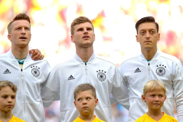 Özil with other players of the team during the national anthem of Germany before the match with South Korea. (Alexander Hassenstein/Getty Images)