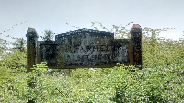 The blackened signage at the site where Kambar was born. 