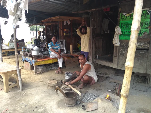 Inderdev Vishwakarma working outside his iron workshop. Veeru Kumar (right) and Jitender Singh in the background. (Prakhar Gupta/Swarajya Magazine)