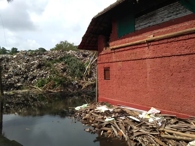 Trash and storm water surrounding Mandara Keshav Bhat’s house.