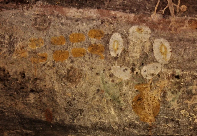 Cave Shelter Nine: Note the yellowish oval circles drawn on the the rock canvas facing the hole through which the sunlight filters through. 