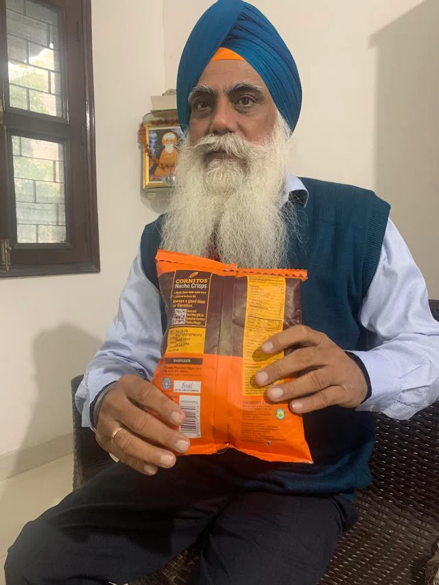 Ravi Ranjan Singh showing <i>halal </i>certified Cornitos chips packet