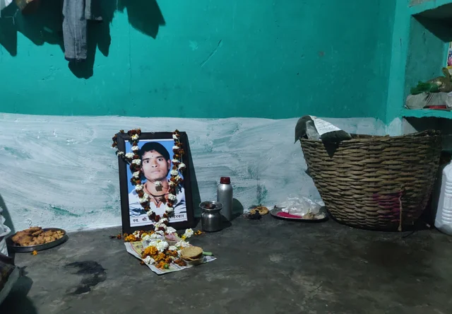 Dhan Prasad Ahirwar’s picture in the room where he was allegedly set afire by neighbours. (Swati Goel Sharma/Swarajya Magazine)