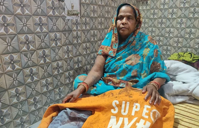 Shakuntala, mother of Lala, shows his blood-soaked sweat-shirt