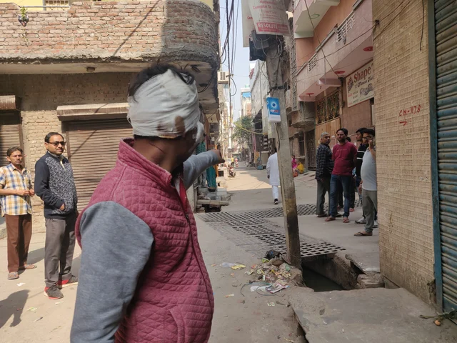 Standing in Moonga Nagar, Lala points to Nehru Vihar where he was allegedly attacked 