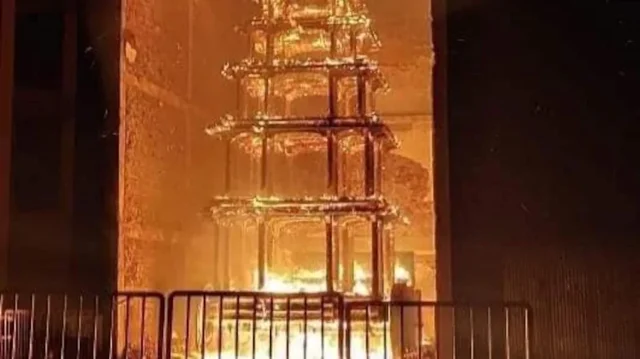 The chariot engulfed by flames.