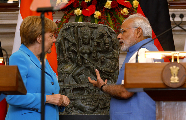 PM Modi with German Chancellor Angela Merkel as she returns a tenth century Durga idol from Kashmir. (Virendra Singh Gosain/Hindustan Times via Getty Images)