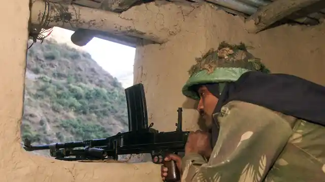 An Indian army soldier guarding a post inside his bunker in Kashmir. (Photo: Reuters)