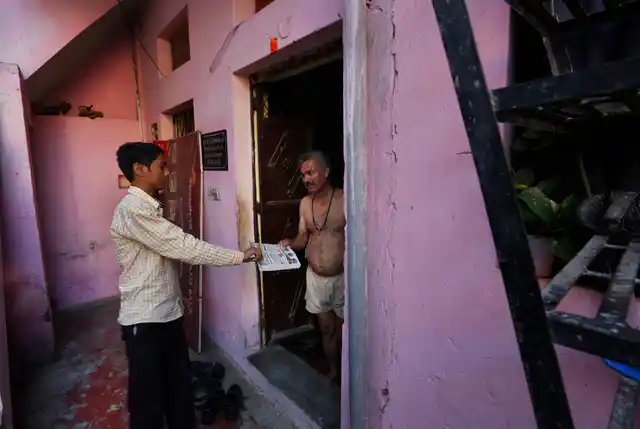 Ved Prakash Shukla gets his morning newspaper. (Photo: AP)