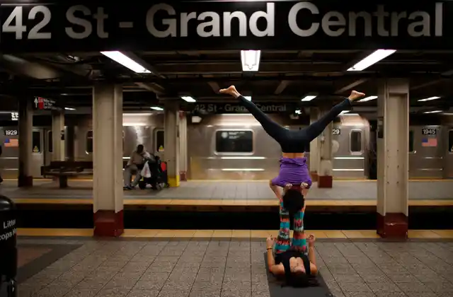 Lauren Tallody (bottom) and Bassam Kubba (top) practice “Acro-yoga”, a mixture of yoga and acrobatics on a subway platform at 42nd Street beneath Grand Central station in New York city. (Photo: Reuters)