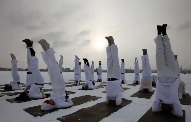 Members of the yoga project ‘Y-8’ practice their ‘Alsteryoga’ on the frozen Alster lake in the northern German town of Hamburg. (Photo: Reuters)