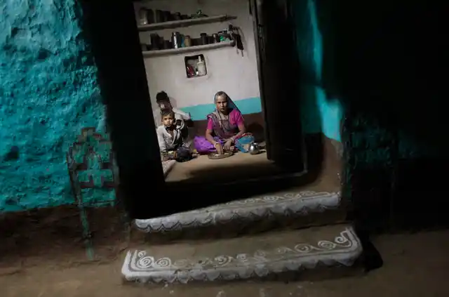 A family eats dinner in their kitchen in the Meerwada village of Madhya Pradesh. (Photo: Reuters) 
