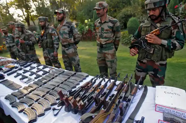 Indian Army soldiers stand behind a display of seized arms and ammunition at a garrison in Srinagar, October, 2013. (Photo: Reuters)
