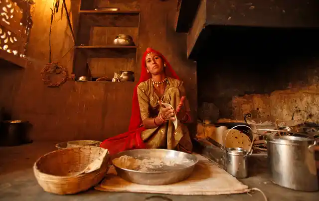 Most Indian kitchens though are little hellholes. Laxmi, 34, who works as a construction labourer, makes a <i>roti</i> inside her house in Rajasthan. (Photo: Reuters)