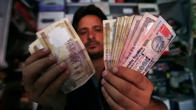 An Indian shopkeeper counts notes at his shop. (Photo: Reuters)