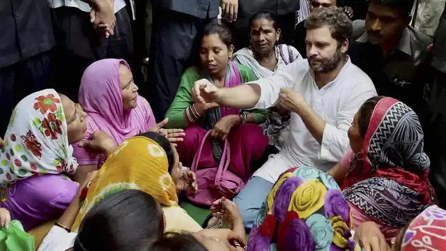 File photo of Rahul Gandhi sitting with sanitation workers at Patparganj. (Photo: PTI)