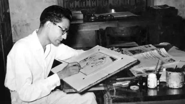 Archival photograph from Raj Thackeray’s book on Bal Thackeray showing him sketching a cartoon for the <i>Free Press Journal</i>.