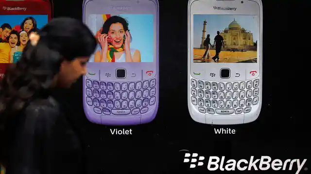 A woman walks past a Blackberry advertisement billboard in Mumbai. 