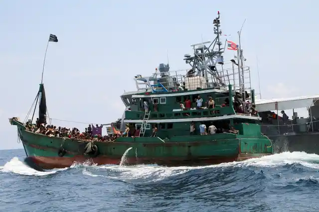 A boat with Rohingyas being towed away from Thailand by a Thai navy vessel in May 2015. (Photo: Reuters) 