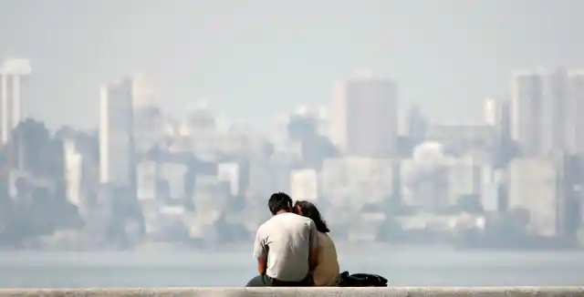 A young couple sits at the seafront in Mumbai (Photo: Reuters)