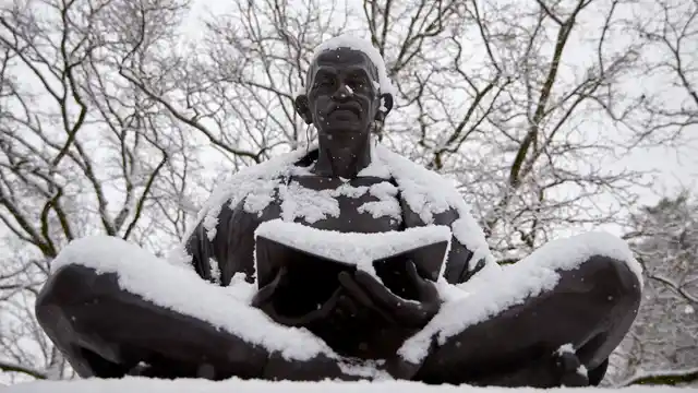 Snow falls on a statue of Mahatma Gandhi on a winter morning in Geneva. (Photo: Reuters)