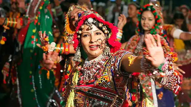 An artist in traditional attire performs Garba in Ahmedabad, Gujarat.