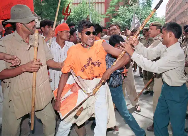 Policemen hold back activists of Shiv Sena during a protest in New Delhi on July 31, 1999. More than 100 activists protested against an order by Election Commission disenfranchising its chief, Bal Thackeray, for six years for making inflammatory public speeches. (Photo: Reuters)