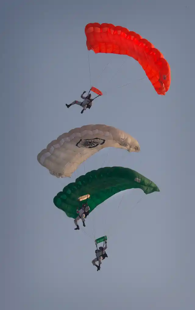 Members of the Indian Air Force Akash Ganga skydiving team display their skills during Air Force Day parade at Hindon Air Force base near New Delhi. (Photo: AP)