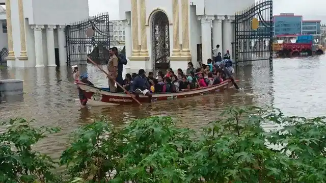 Students of Satyabhama University in Chennai being taken to building in a boat. (Photo: Sameer Yadav)