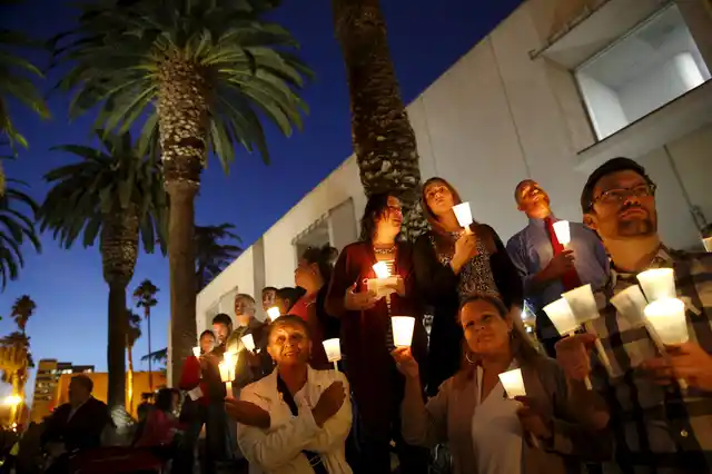 People hold candles during a vigil in San Bernardino, California. (Photo: Reuters)