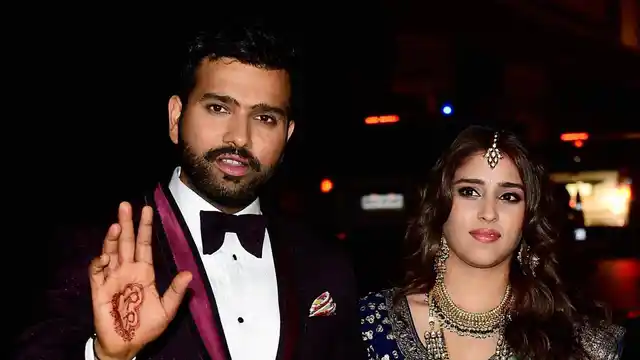 Rohit Sharma and his wife Ritika Sajdeh wave to the crowd. (Photo: PTI)