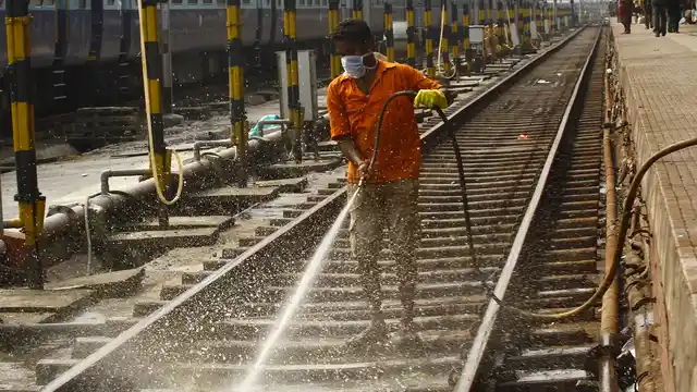 Open defecation along railway tracks and roads are a problem in urban India as well. A worker cleans a railway track at a railway station in Kolkata. (Photo: Reuters)