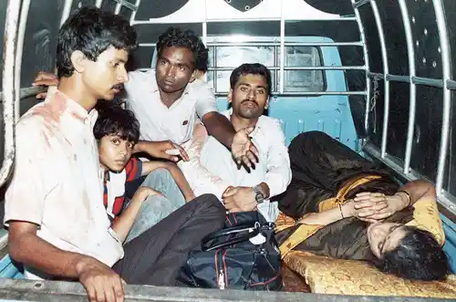 Unidentified passengers from the hijacked Pan Am airliner sit in an official government truck being brought to the local Jinnach hospital for medical treatment in Karachi, Pakistan on Friday, September 6, 1986. (Photo: AP)