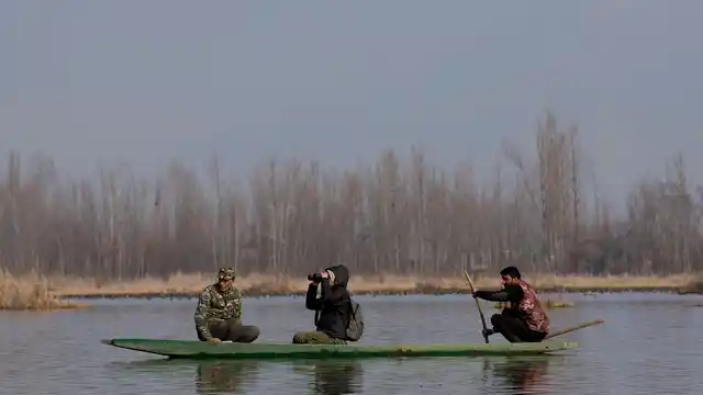 Volunteers and officials participate in the monitoring of water-bird population at Hokersar. (Photo: AP)