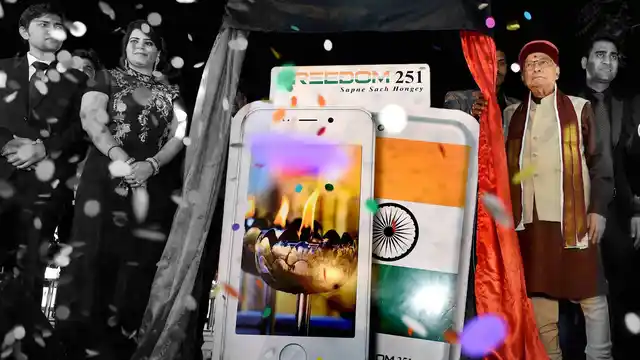 BJP Senior leader Murli Manohar Joshi, Director of Ringing Bells, Mohit Goel and CEO, Dhaarna Goel during the launch of Smartphone-Ringing Bells Freedom 251 on 17 February. (Photo: PTI/Altered by <b>The Quint</b>)