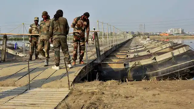 Army personnel construct temporary bridges over Yamuna river for the three-day World Peace Festival organised by spiritual guru Sri Sri Ravi Shankar in New Delhi on Tuesday. (Photo: PTI)