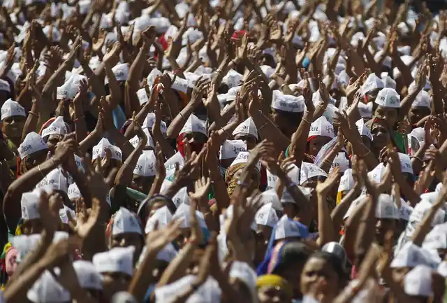 Members of the Patel community raise their arms as they attend a protest rally at Mahesana town, in Gujarat. Thousands of community members on Sunday held a protest rally to demand reservation for their community. (Photo: Reuters/Amit Dave)