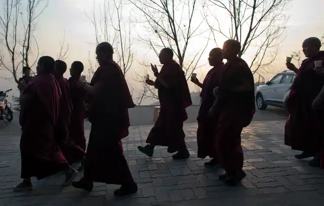 Exiled Tibetans march on foot during a candlelit vigil in solidarity with two Tibetans, who immolated themselves demanding freedom for Tibet, in Dharmsala, on Wednesday. (Photo: AP Photo/Ashwini Bhatia)